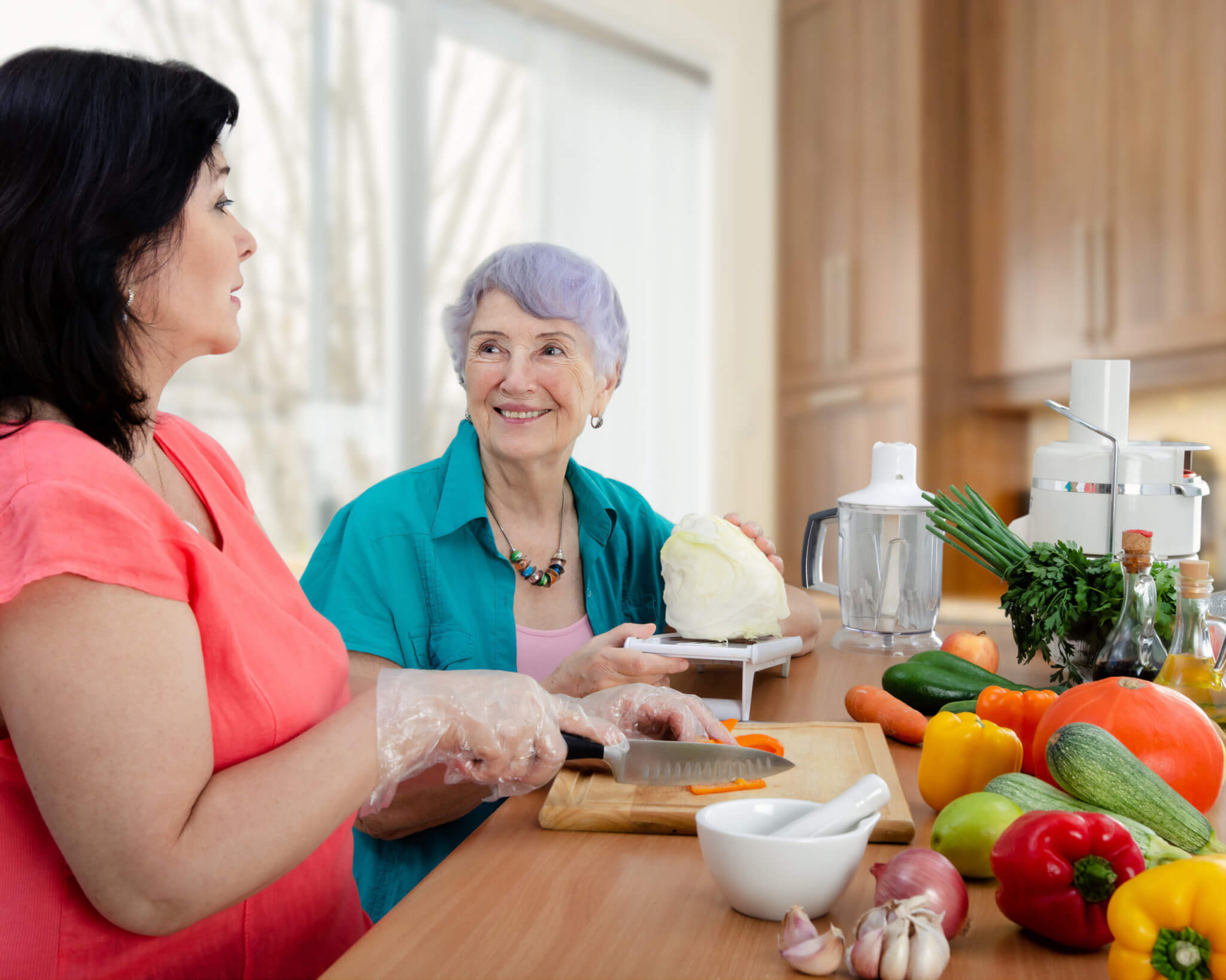 Female,Caregiver,Or,Volunteer,And,Senior,Adult,Woman,Cook,Vegetable